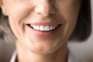 Close up of beautiful older woman smile after whitening procedure, demonstrate healthy teeth, feel satisfied visiting dental clinic, oral treatment, enamel cleaning. Health, restoration, dentalcare